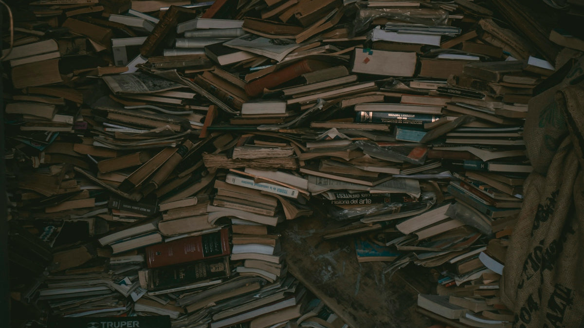 a pile of books sitting on top of a wooden floor