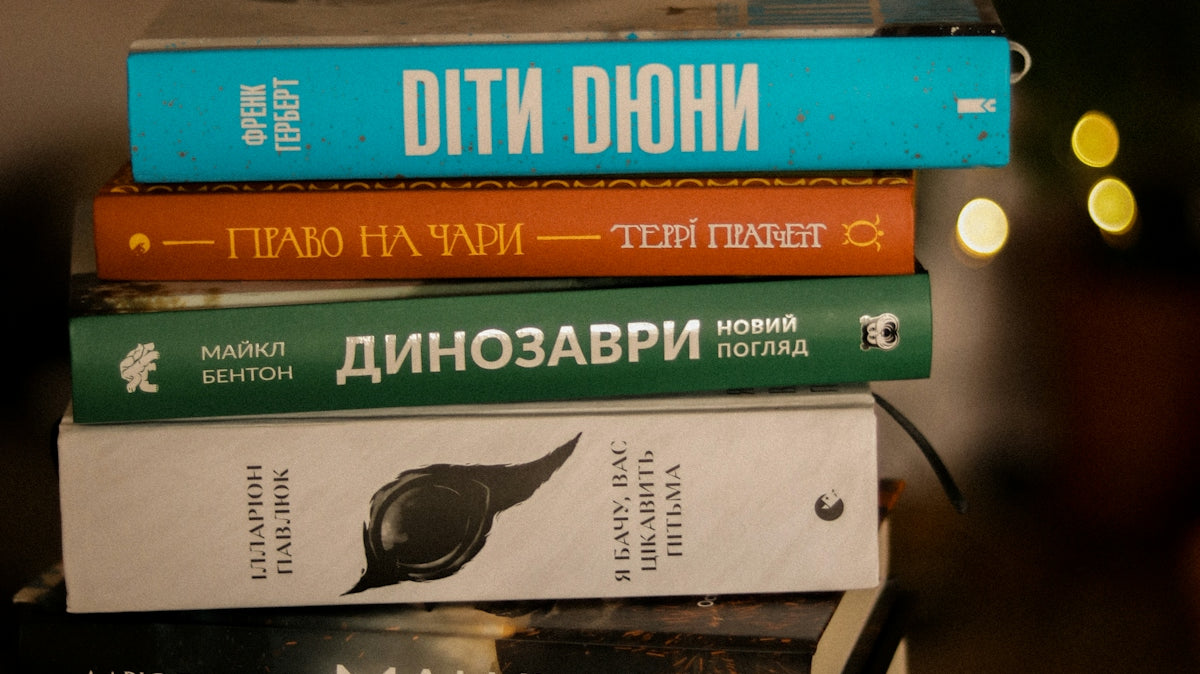 A stack of books sitting on top of a wooden table